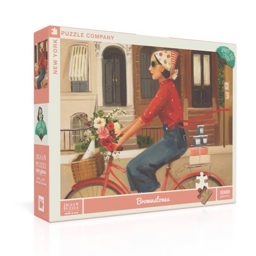 A Brownstones Puzzle of a woman riding a red bicycle with a basket of flowers in front of a building with windows and doors, crafted by Janet Hill, by New York Puzzle Company.