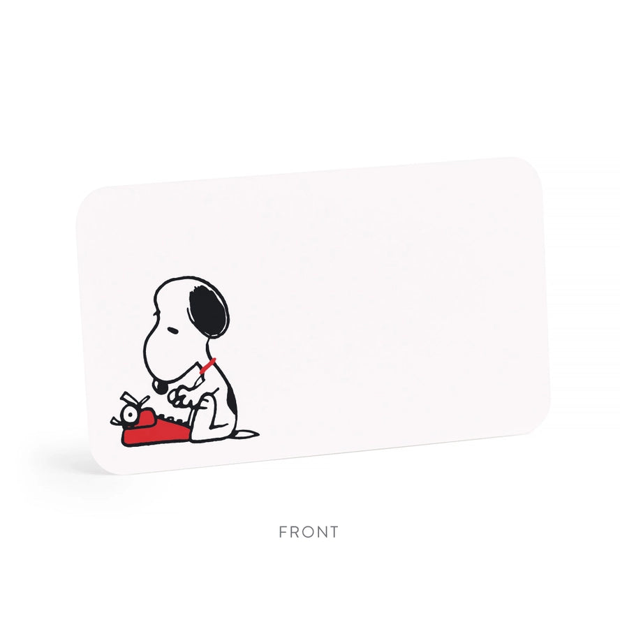 A white rectangular product with rounded corners, shown at a slight angle on a white background. The front features a small black-and-white cartoon dog sitting with a red typewriter.