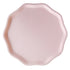 Pink compostable plate with a scalloped edge on a white background.