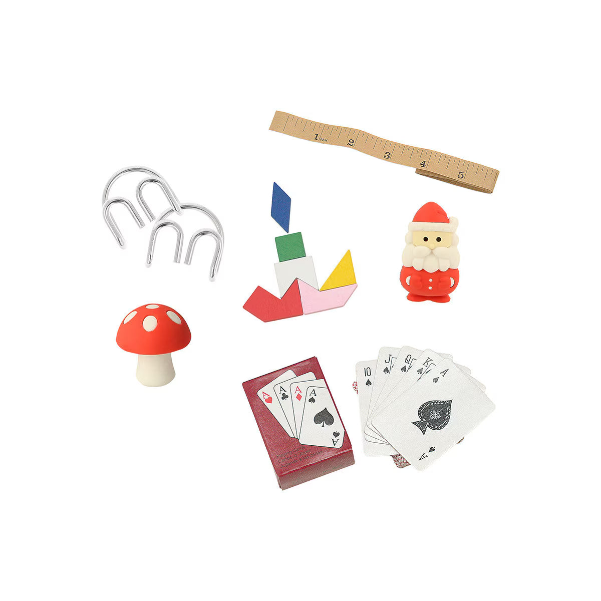 Collection of small toys and items including a mushroom, rake, cards, and ruler on a white background
