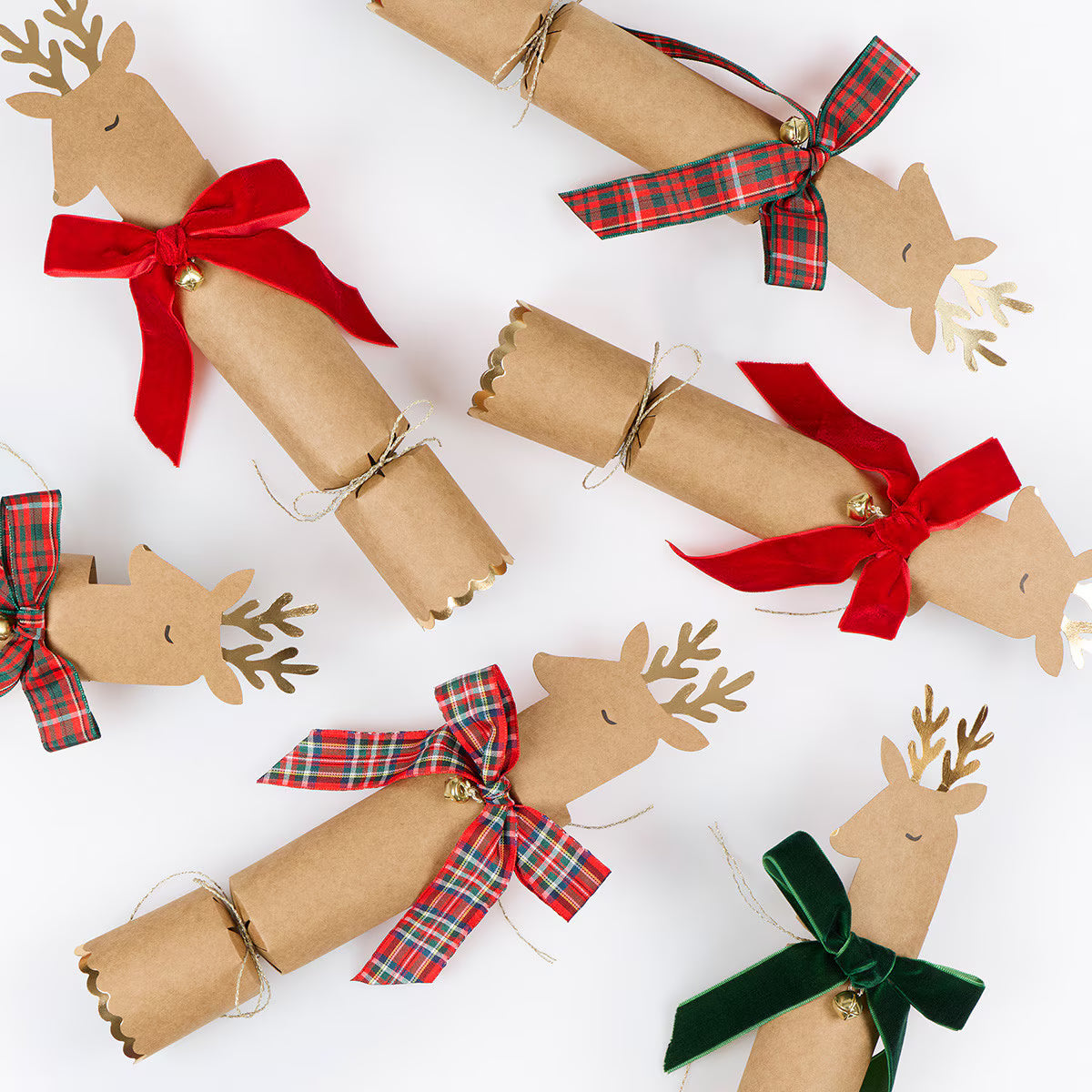 Decorative cracker shaped like reindeer with colorful bows on a white background