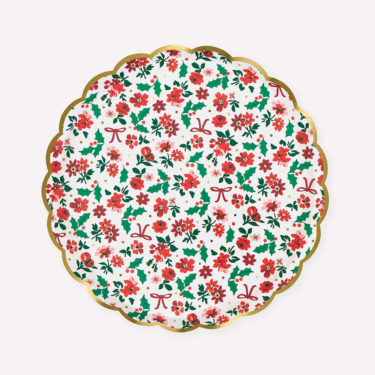 A scalloped round paper plate featuring a festive Christmas floral pattern with red poinsettias, green holly leaves, and red bows on a white background, finished with a gold scalloped rim.