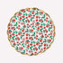 A scalloped round paper plate featuring a festive Christmas floral pattern with red poinsettias, green holly leaves, and red bows on a white background, finished with a gold scalloped rim.