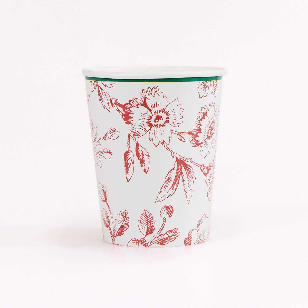 A white paper cup with a red floral pattern and a thin green rim, photographed on a clean white background.