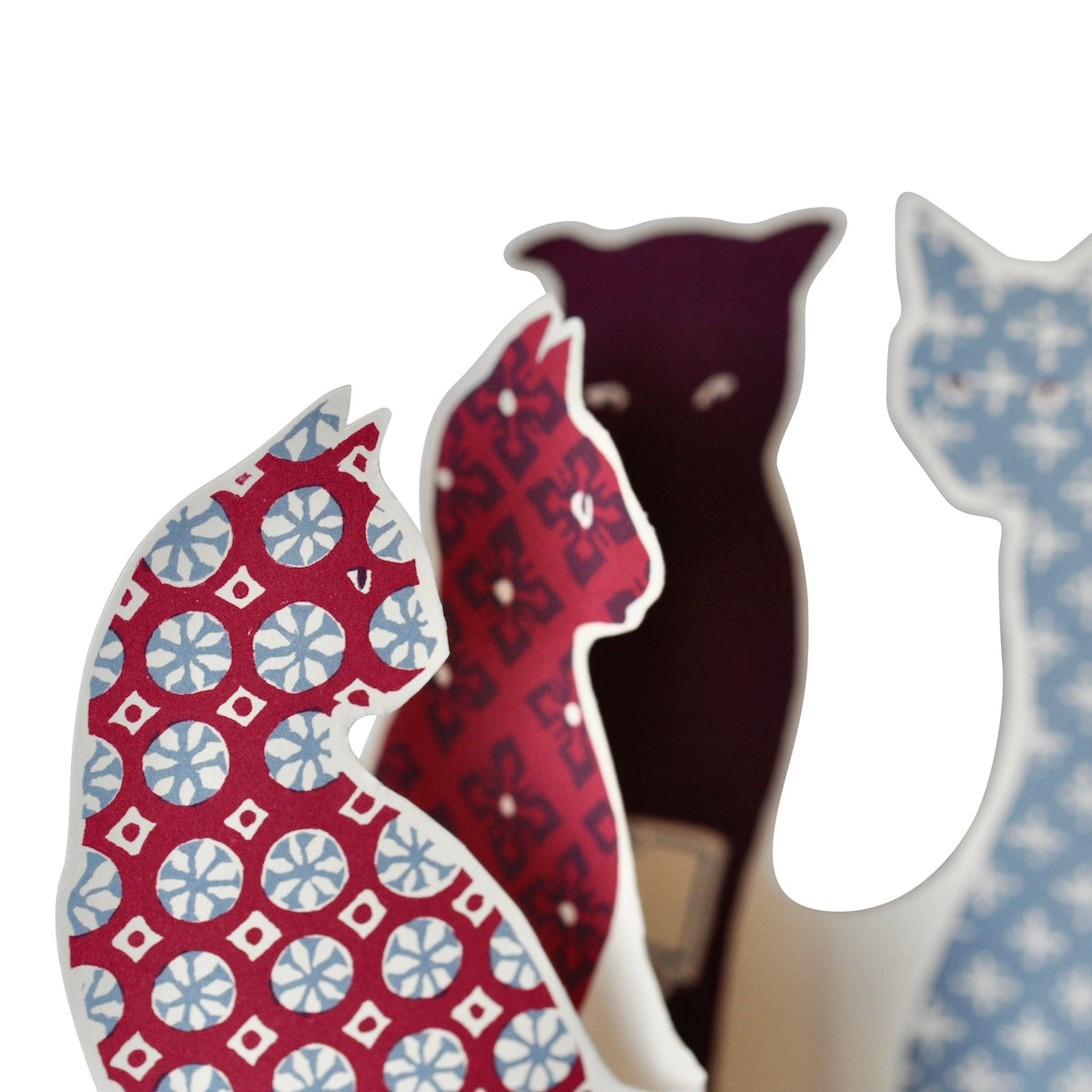 Greeting card in the shape of cats with calico printing on them. 