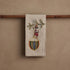 Decorative towel with embroidered design of a bear and Christmas elements on a wooden rod.