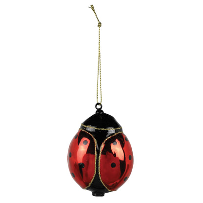 A Glass ladybug ornament with a gold string.