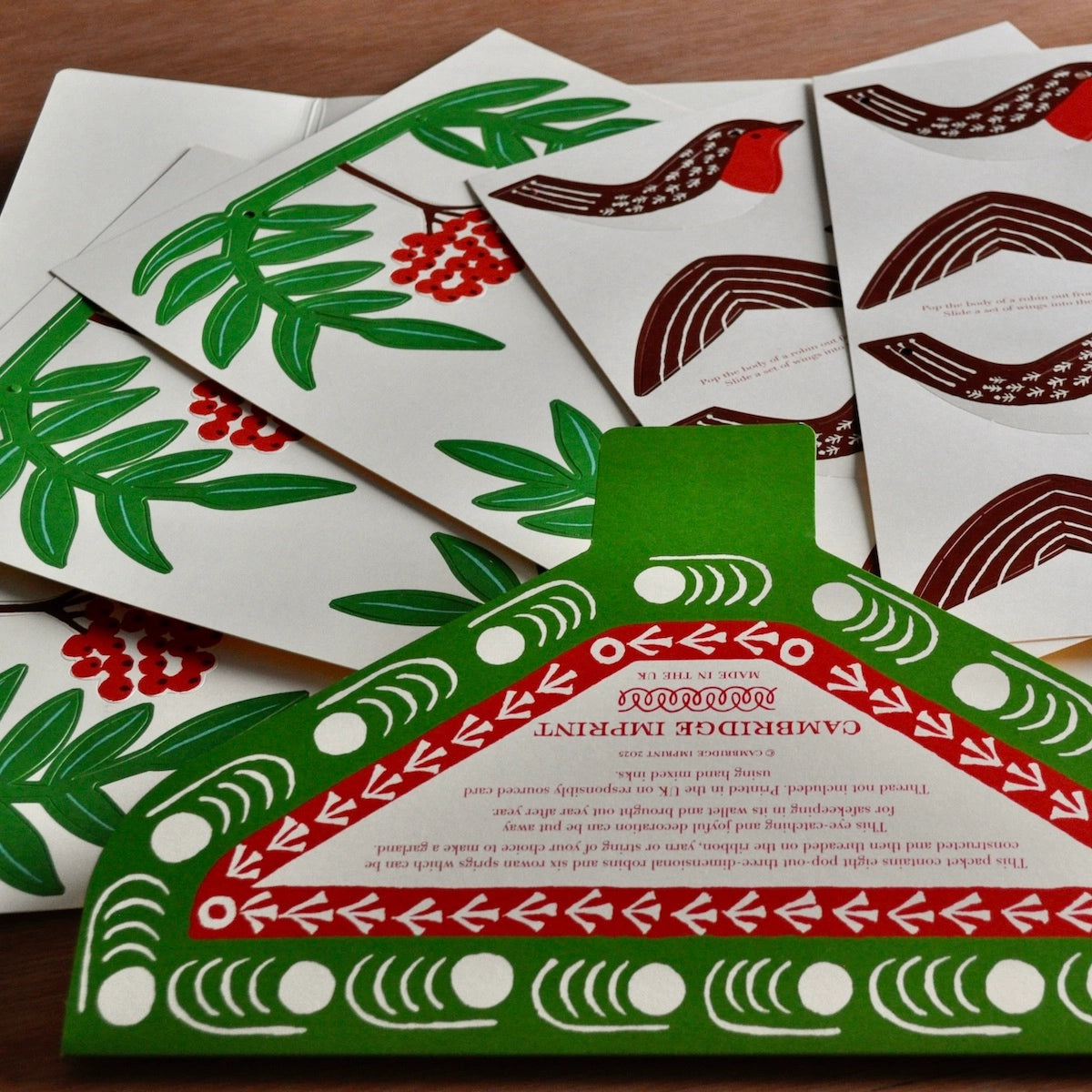 The paper garland pieces in their die-cut sheets fanned out from within the package. 
