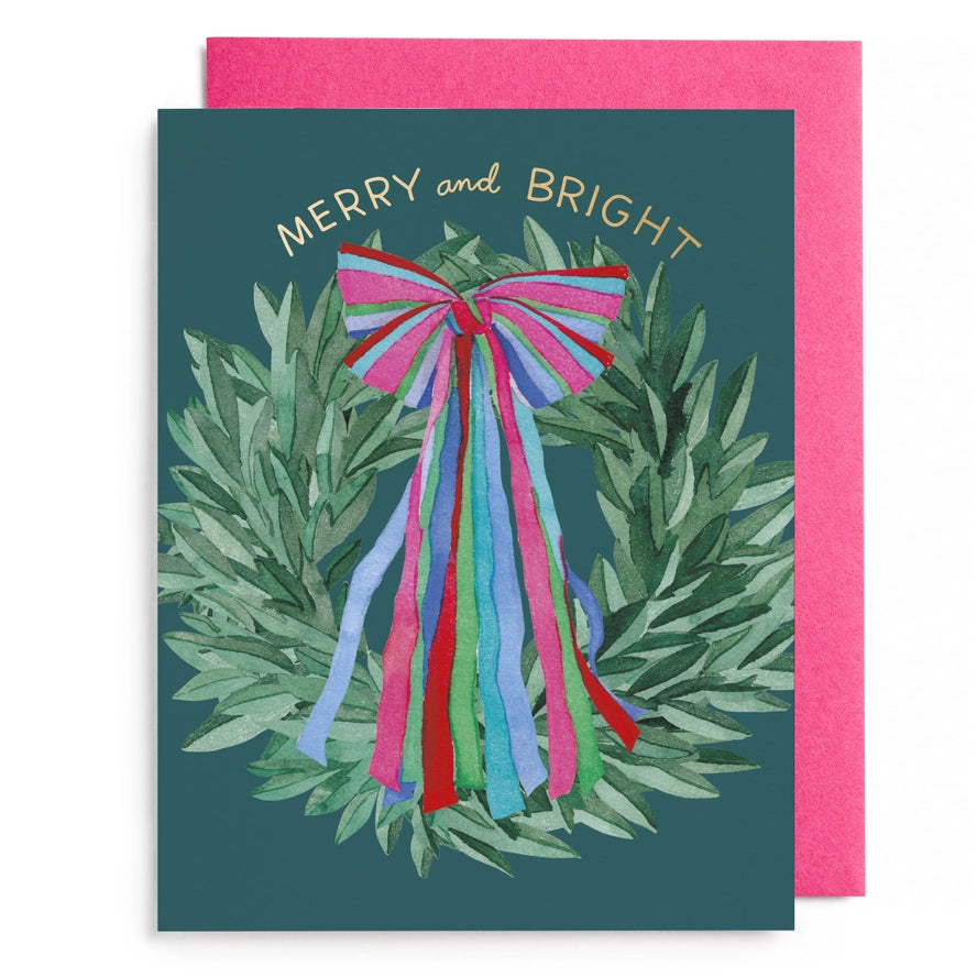 Greeting card with festive wreath and colorful bow design, featuring the text &