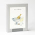 A box of cards featuring a watercolor illustration of champagne glasses and a bottle in an ice bucket, with text that says "let&