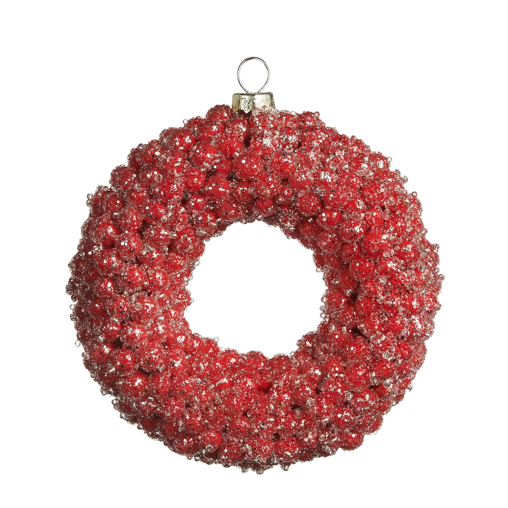 Red beaded wreath ornament on a white background.