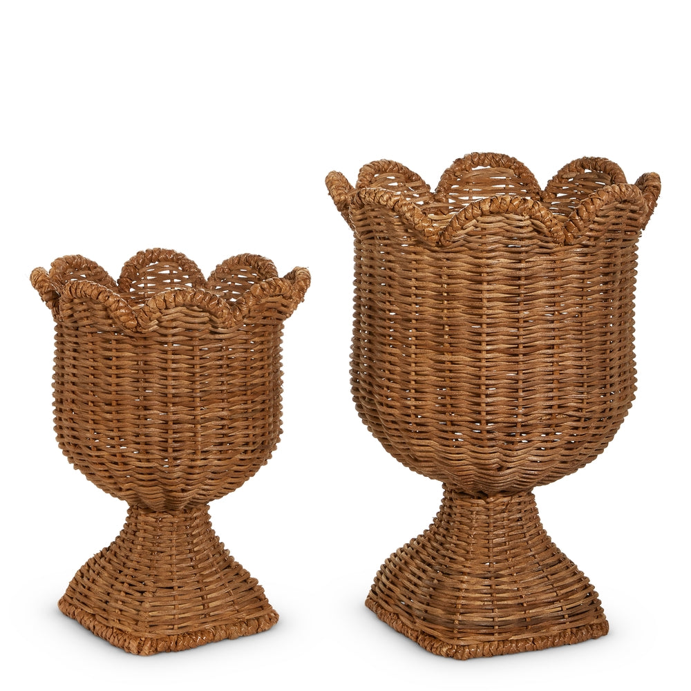 Two wicker candle holders with scalloped edges on a white background