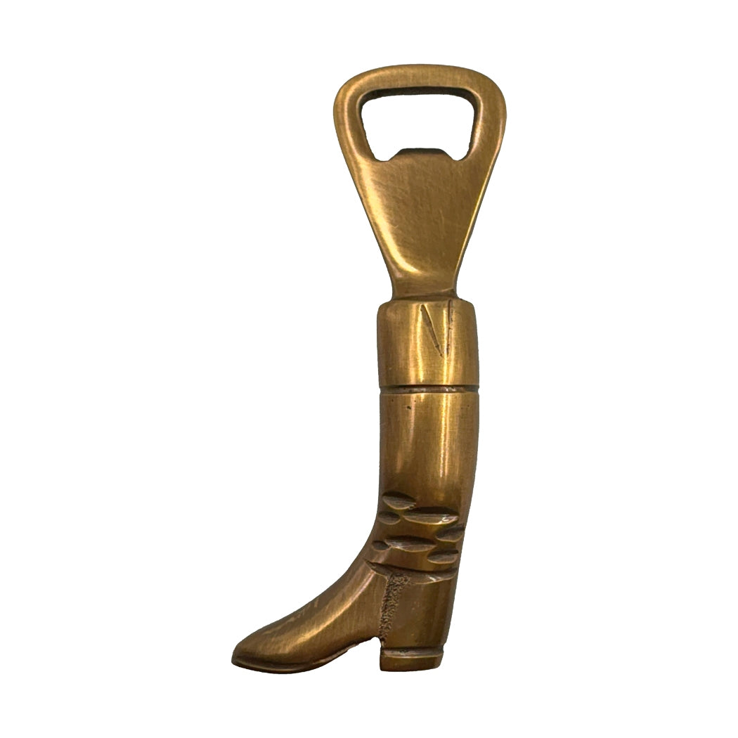 Brass boot-shaped bottle opener on a white background.