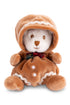 A plushie bear wearing a gingerbread costume with a plaid bowtie on a white background.