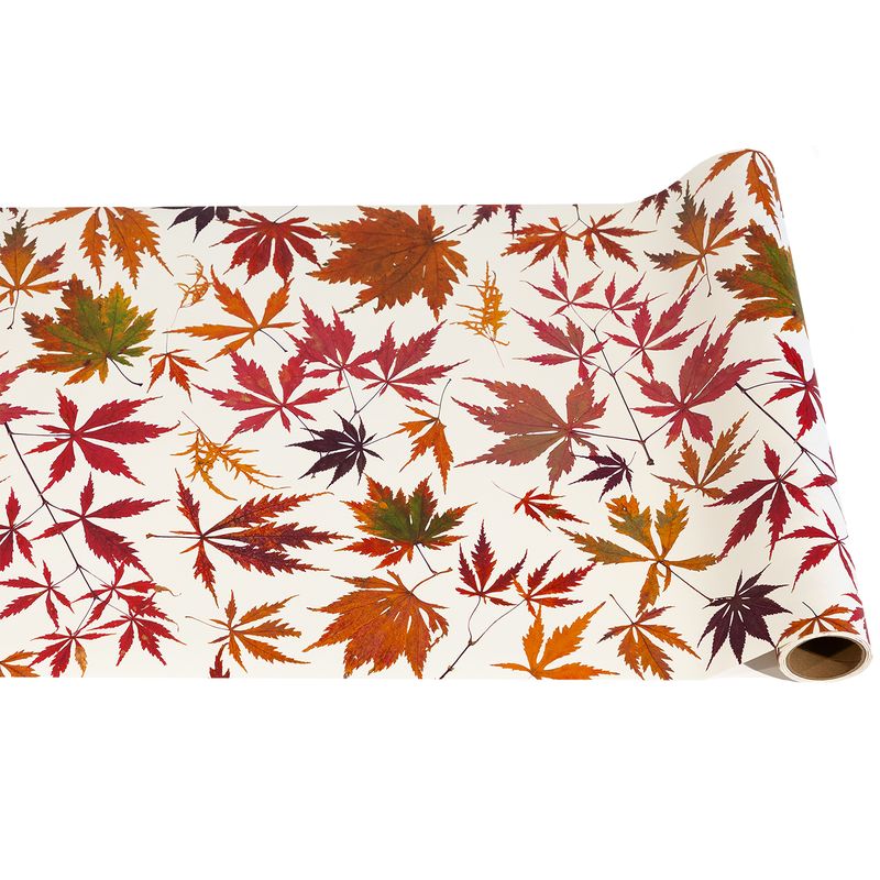 Roll of paper with autumn leaf pattern on a white background