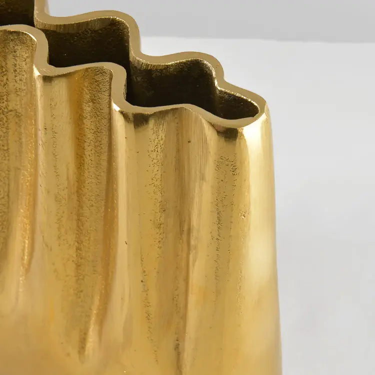 A close up of the Tall Aluminum Gold Wave Vase showing the wavy design at the opening.