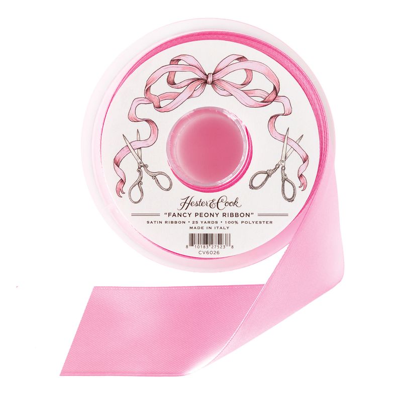 A spool of pink satin ribbon by Hester &amp; Cook on a white background. 