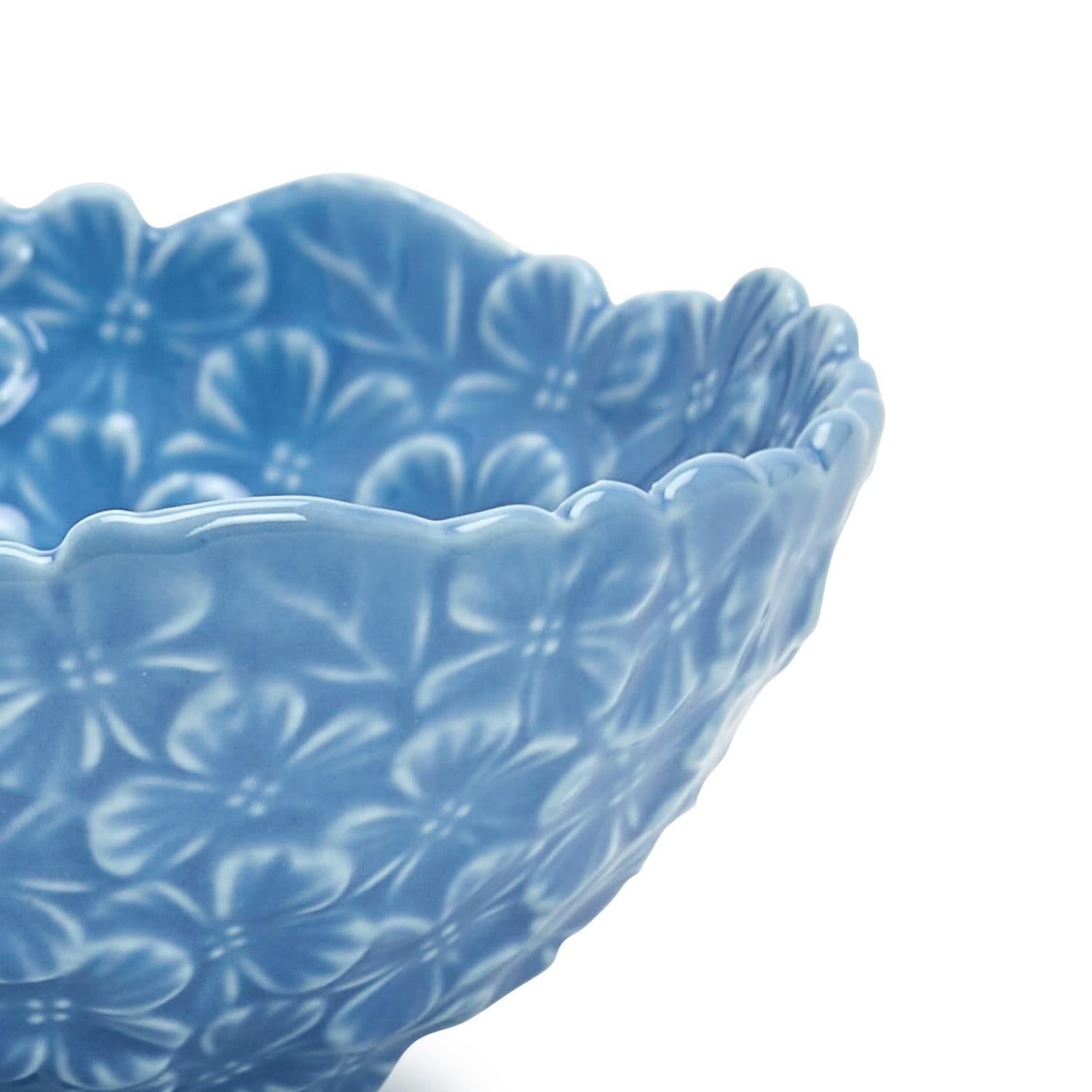 Blue ceramic bowl with a hydrangea pattern on a white background.