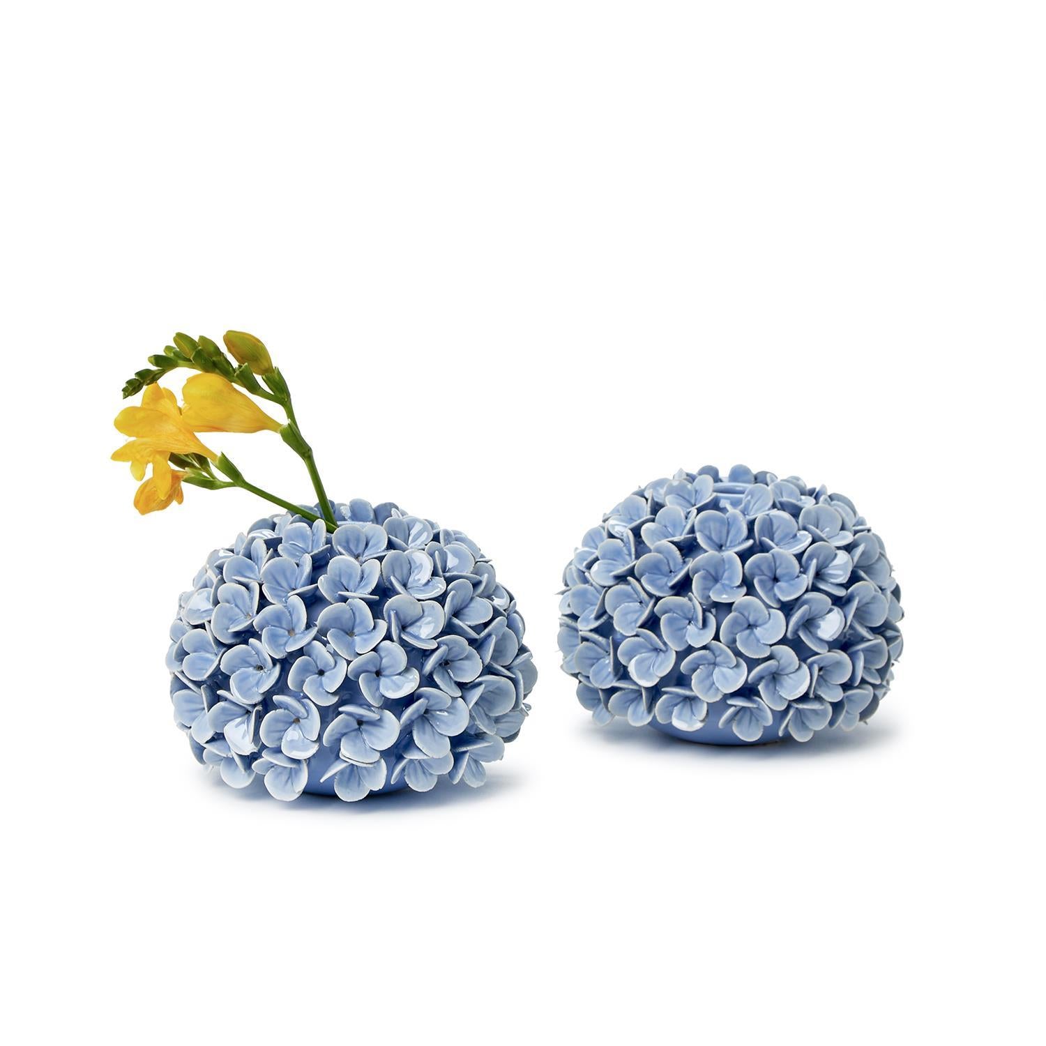 Hydrangea Flower Bud Vase/Taper Candle Holders with one holding a yellow flower.
