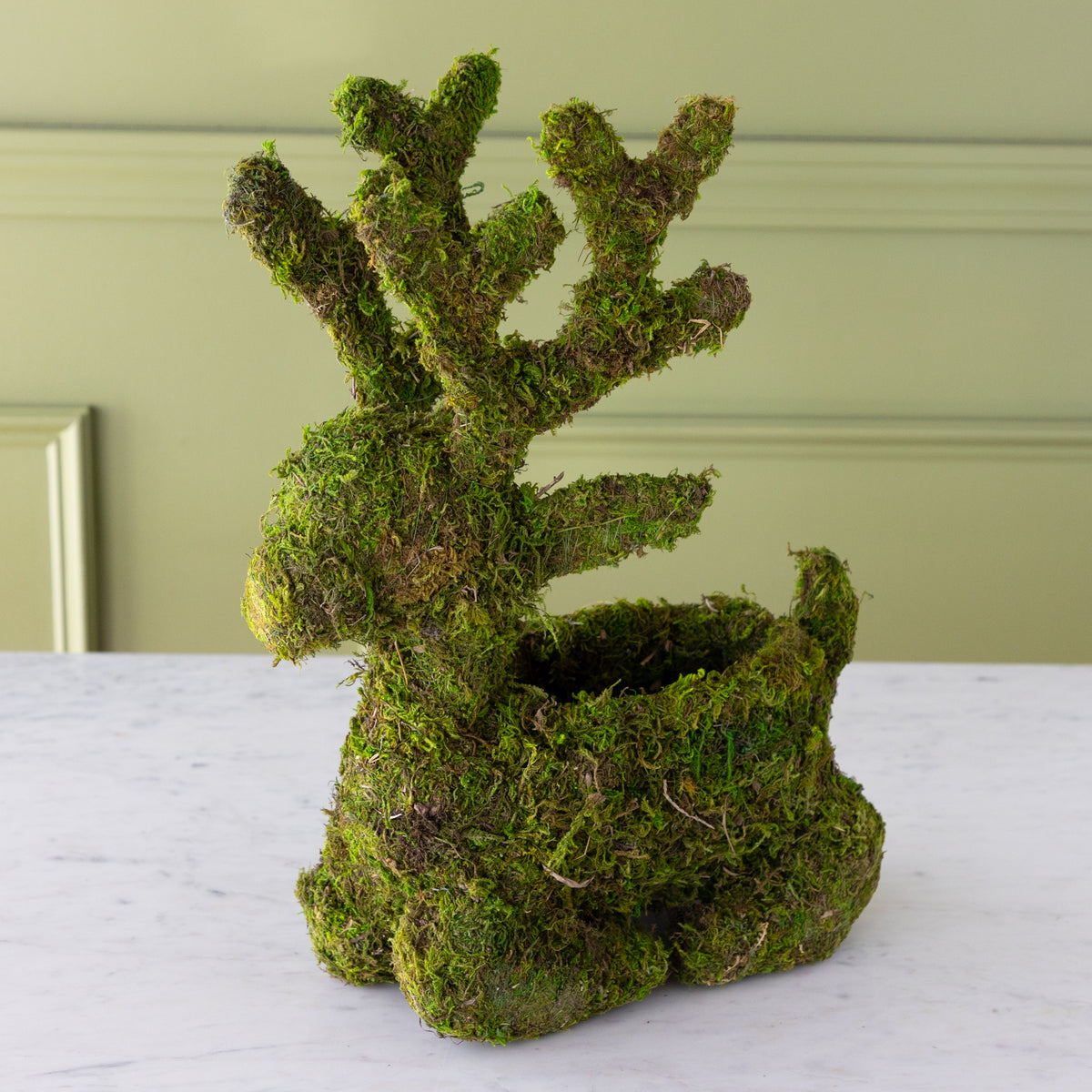 Sitting moss-covered reindeer planter with a space in it&