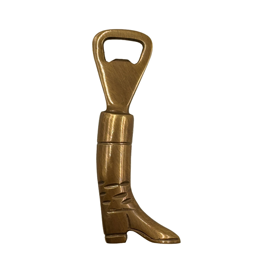 Brass boot-shaped bottle opener on a white background.