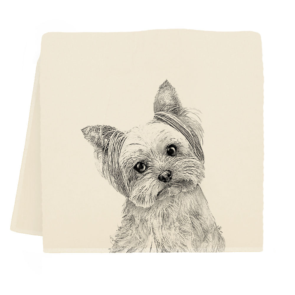 Tea towel with a black and white illustration of a dog on a beige background.