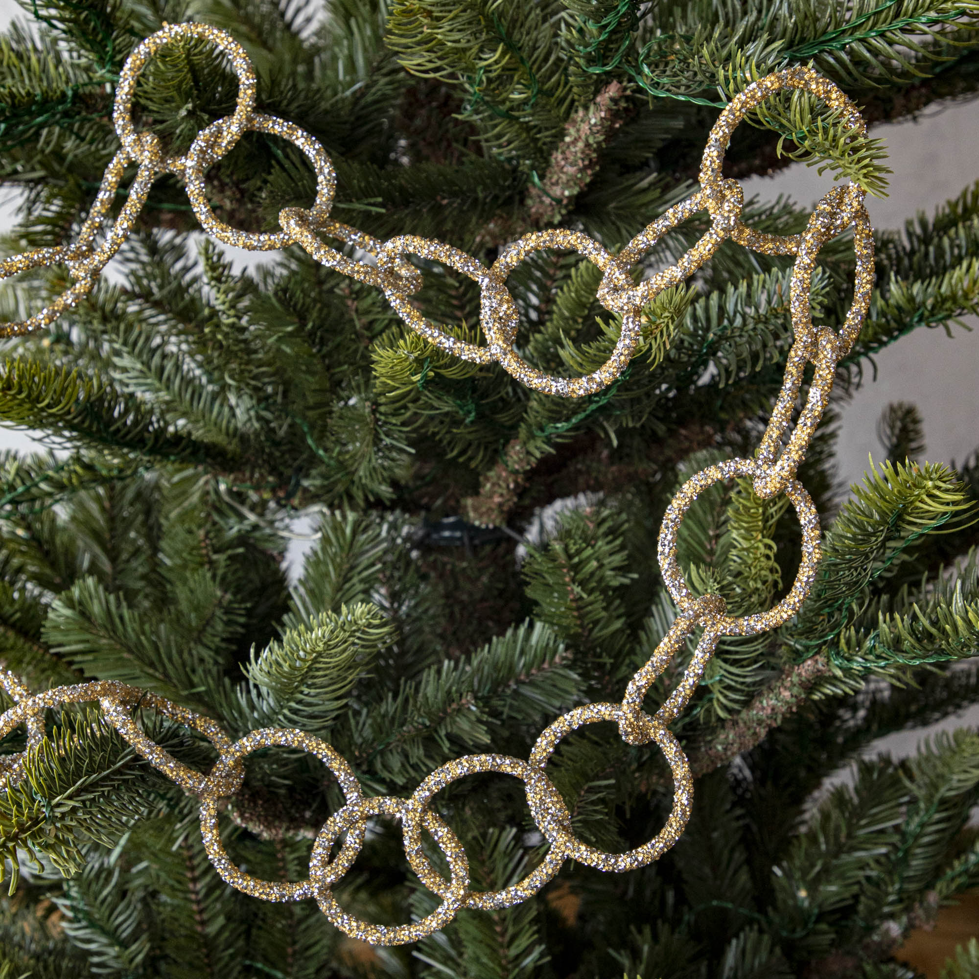 Gold &amp; silver sparkly ring garland hanging in tree.