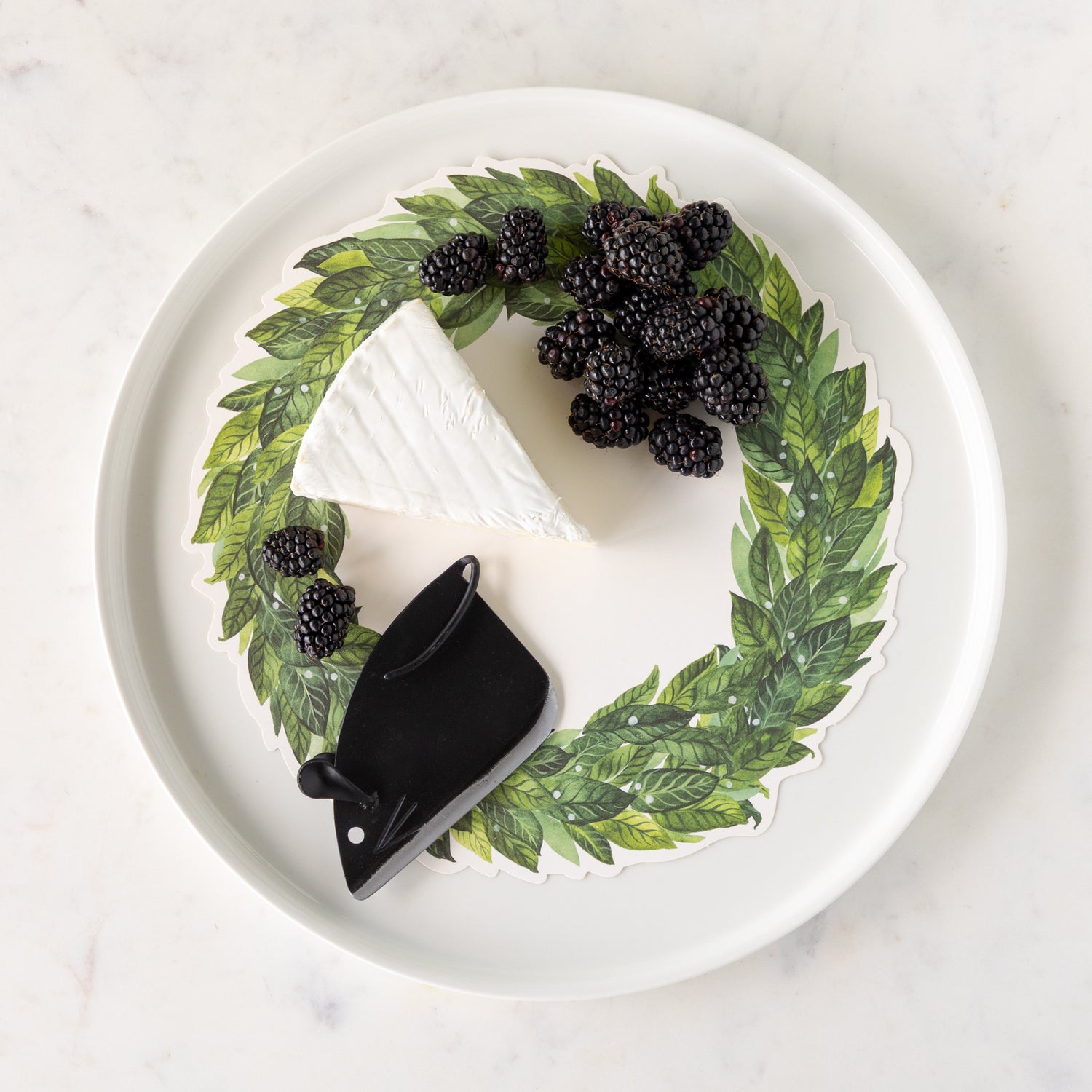 White plate with the Winston Cheese Knife, blackberries, wedge of cheese and Laurel Wreath Serving Paper atop.
