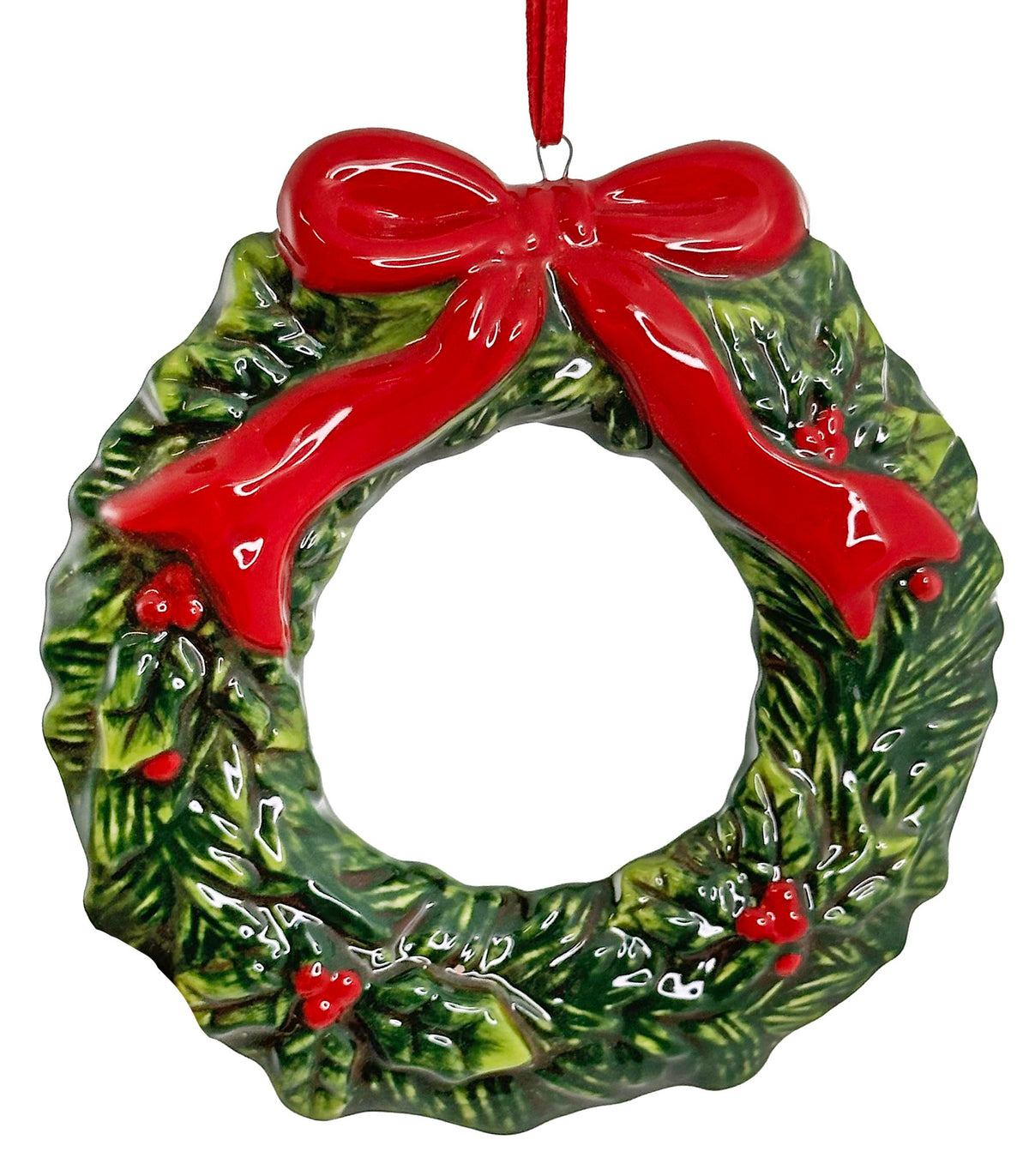 Christmas wreath ornament with a red bow and holly on a white background.