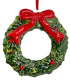 Christmas wreath ornament with a red bow and holly on a white background.