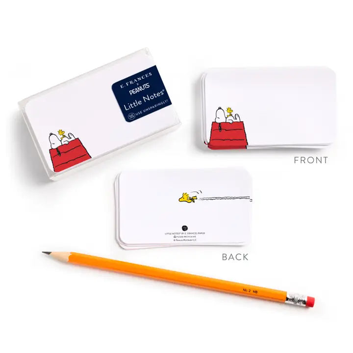 A set of white rectangular notepad cards featuring Peanuts character Snoopy and his red dog bag, shown with front and back views and a yellow pencil on a clean white background.