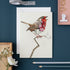 Greeting card featuring artwork by Daniel Mackie of a robin on a twig. 