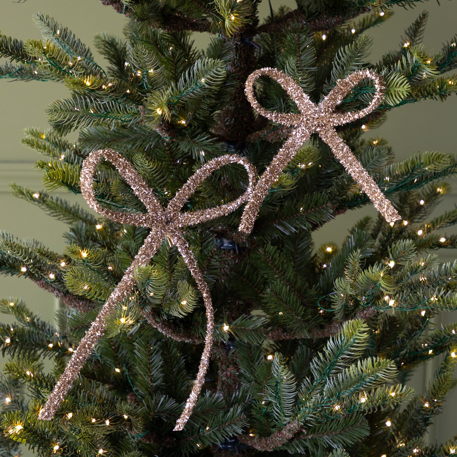 Champagne Gold Glitter Bows with Clips on a lit Christmas tree.