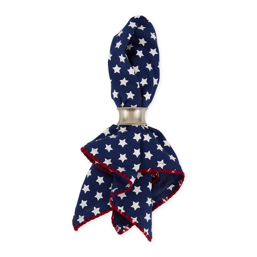 Napkin ring with a blue napkin with white star pattern on a white background.