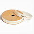 A roll of white ribbon with gold foil &