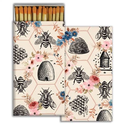 Matches with bee and honeycomb design on a white background