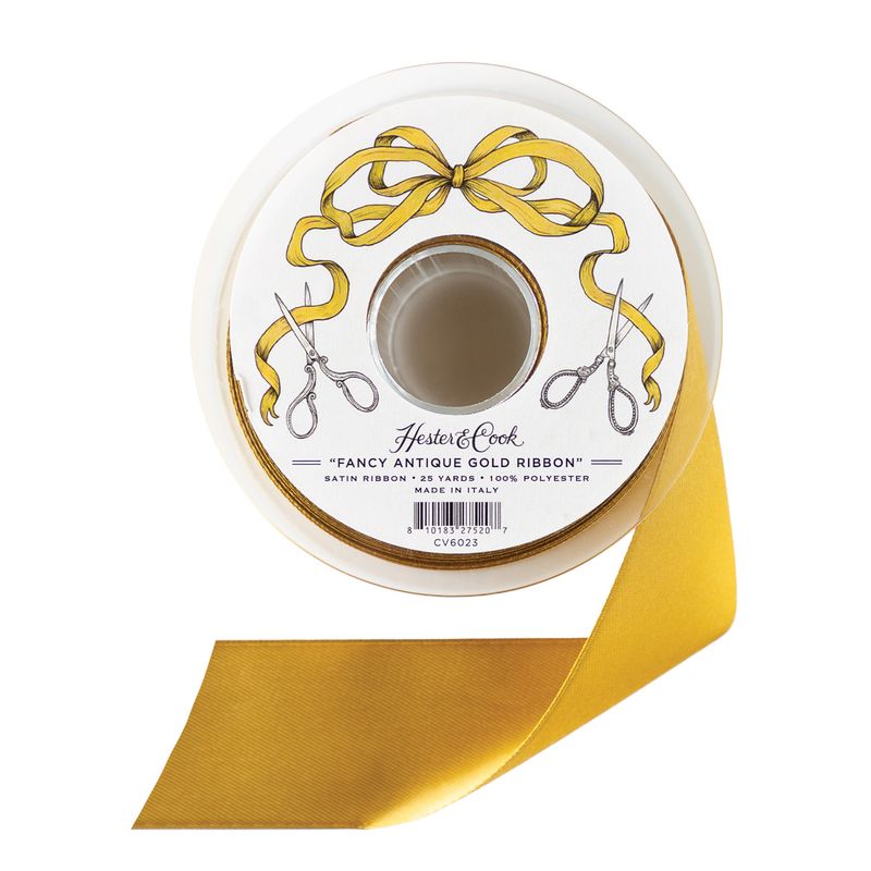 A spool of golden satin ribbon by Hester &amp; Cook on a white background.