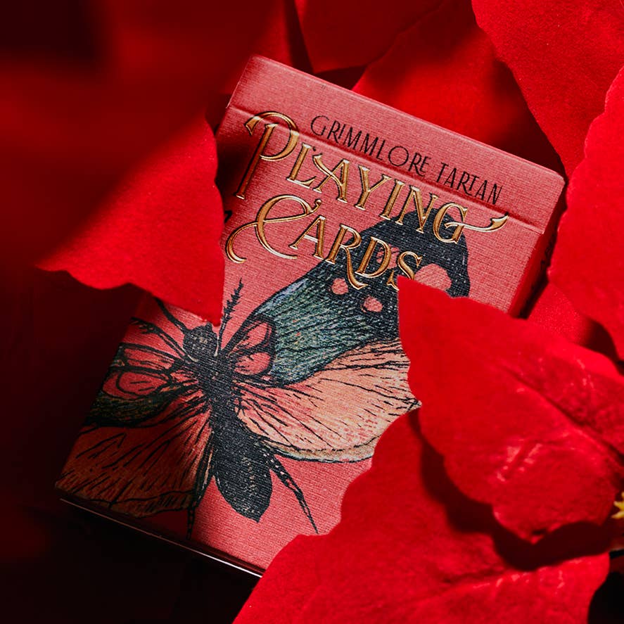 Playing cards with butterfly design on a red background