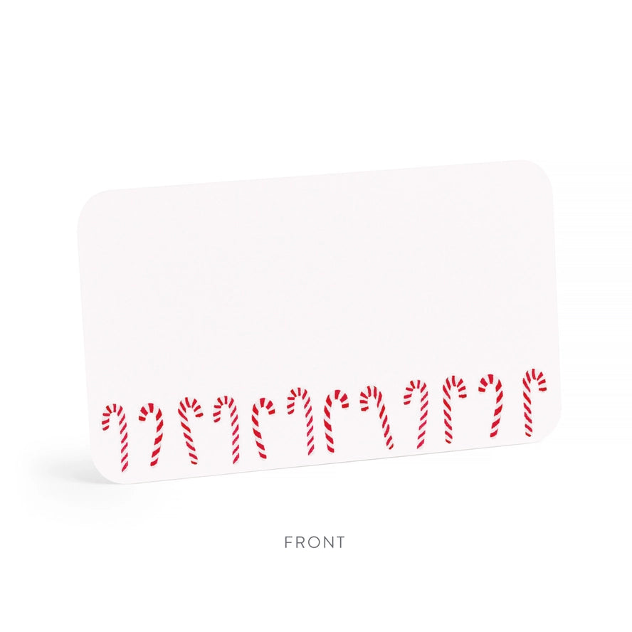 A white rectangular card or label with rounded corners, shown at a slight angle on a white background. The bottom edge features a row of red-and-white striped candy cane illustrations, and the word FRONT is printed below the card.