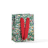 A small square gift bag with a floral pattern on a green background and red ribbon handles.