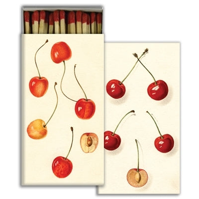 Matchbox with red cherries design on a white background.
