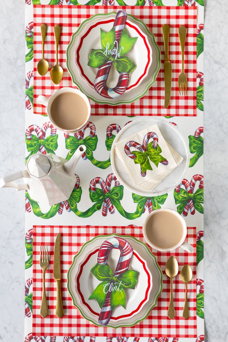 A candy cane themed runner on a holiday tablescape. 