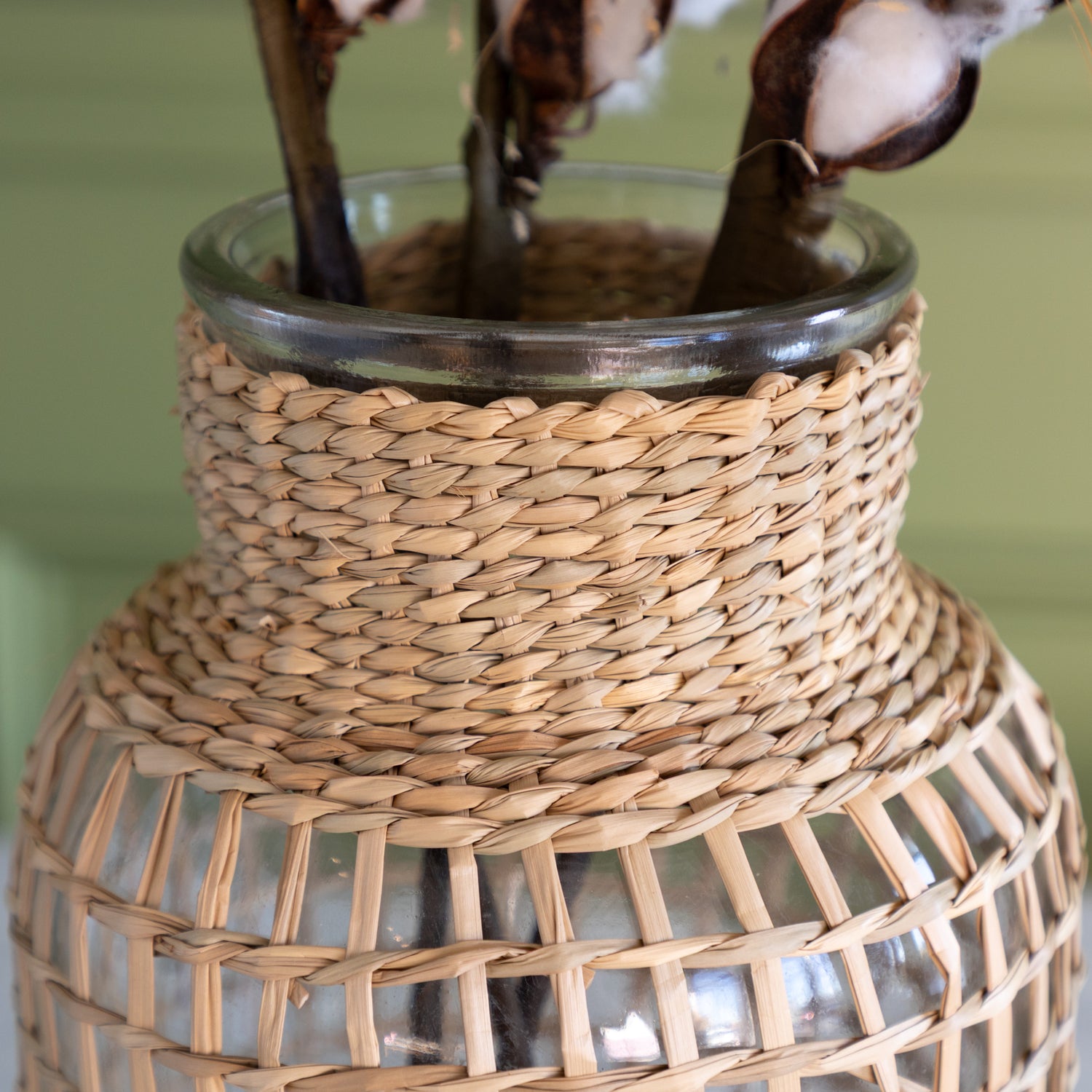 A close up of the large Rattan Wrapped Glass Vase.