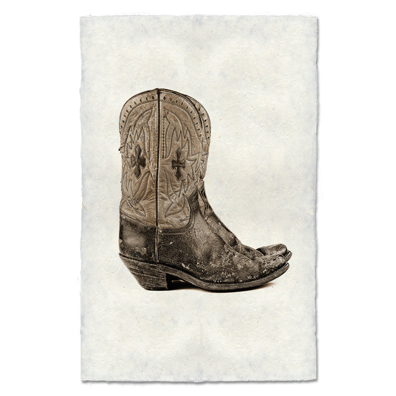 Black &amp; white photo of a pair of well worn boots. 