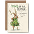 An illustration of a standing reindeer, posing with a Christmas tree dress on and the words "I&