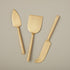 Three Matte Gold Cheese Spreaders Set of 3 by Be Home arranged neatly on a light background.