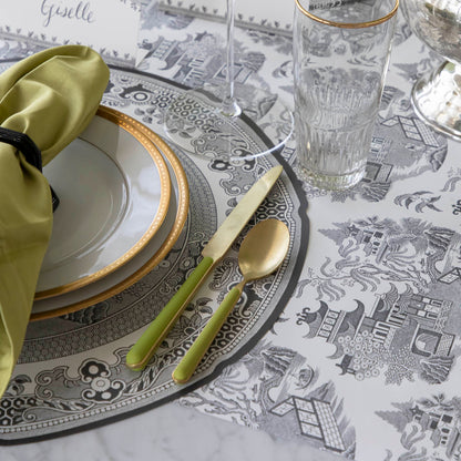 Die-cut Blue Willow Placemat on the Black Willow Runner and an elegant place setting on top.