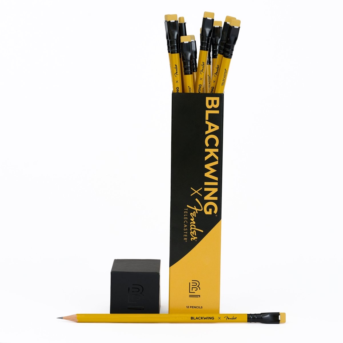 A set of 12 Fender x Blackwing electric guitarspencils in a black and yellow packaging, shown with two loose pencils and a black eraser on a white background.