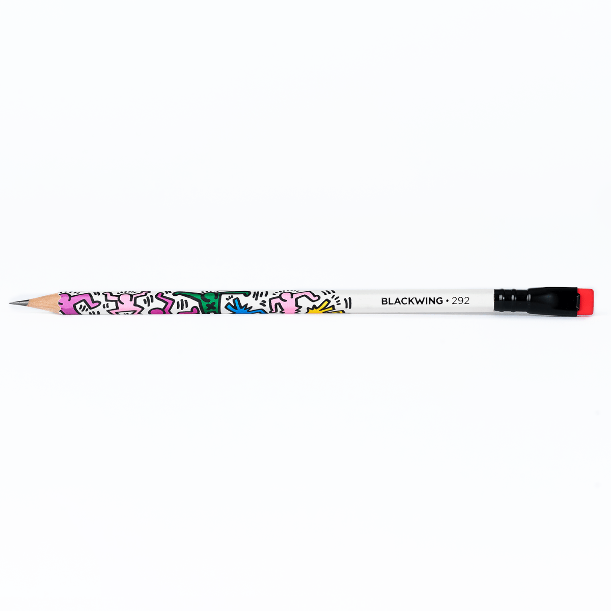 Blackwing pencil with colorful artwork by artist Keith Haring on a white background.
