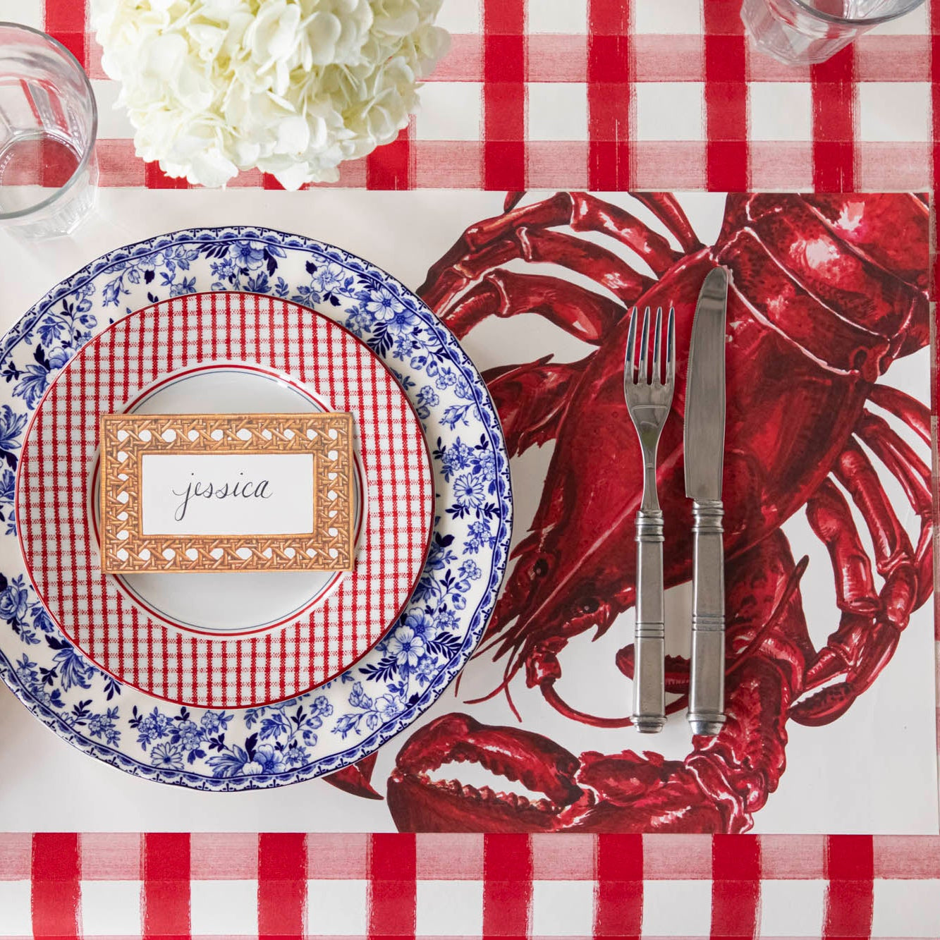 Maine Lobster Placemat on the Red Painted Check Runner with a place setting on top.